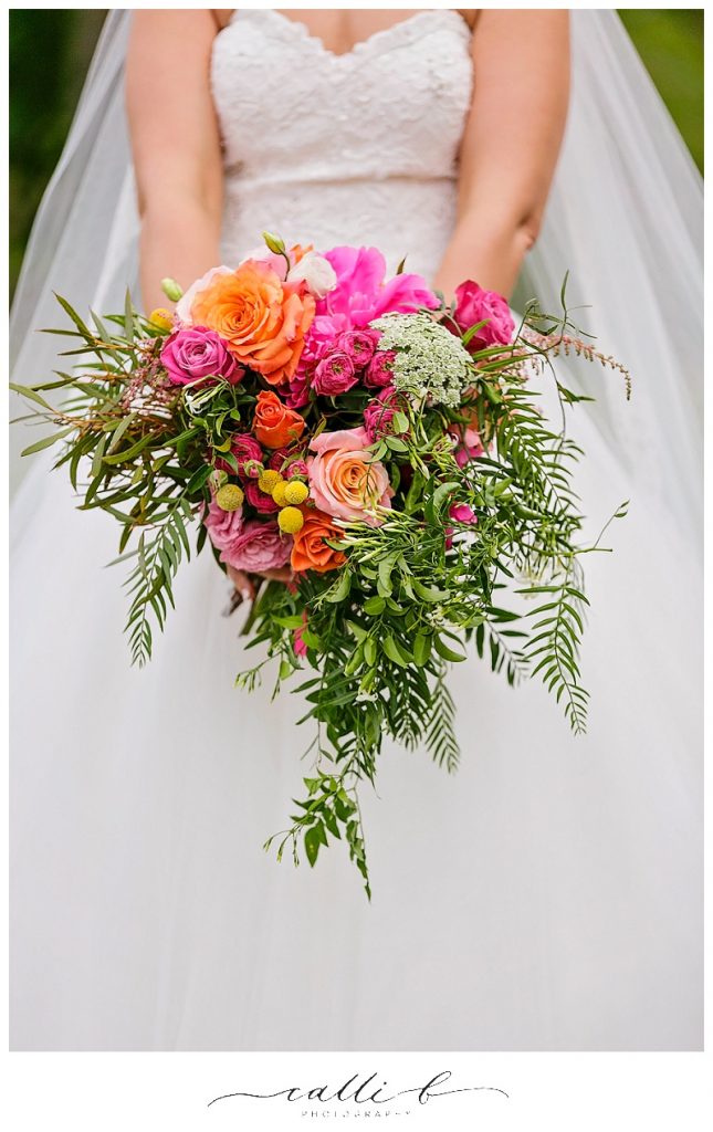 Bright gardenesque wedding bouquet featuring roses and jasmine